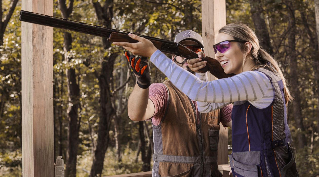 Instructor guided a student aiming a shotgun at the Orvis Sandanona Shooting Grounds, Millbrook